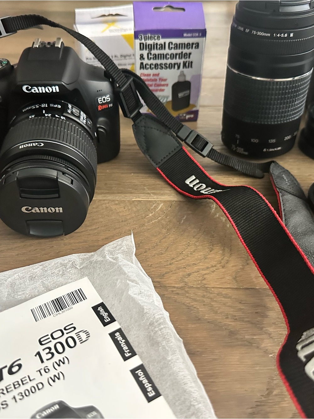 Canon DSLR Camera with Black Body and Black Strap Trimmed in Red